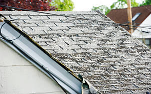 Close-up of weathered slate roof tiles on a house.