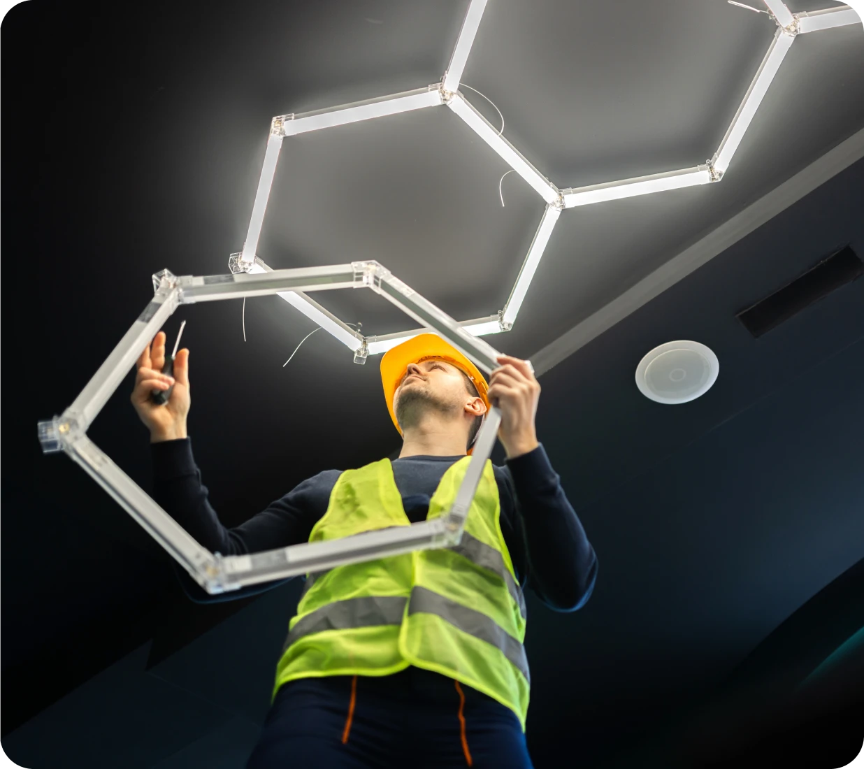 Person in hard hat setting up lights