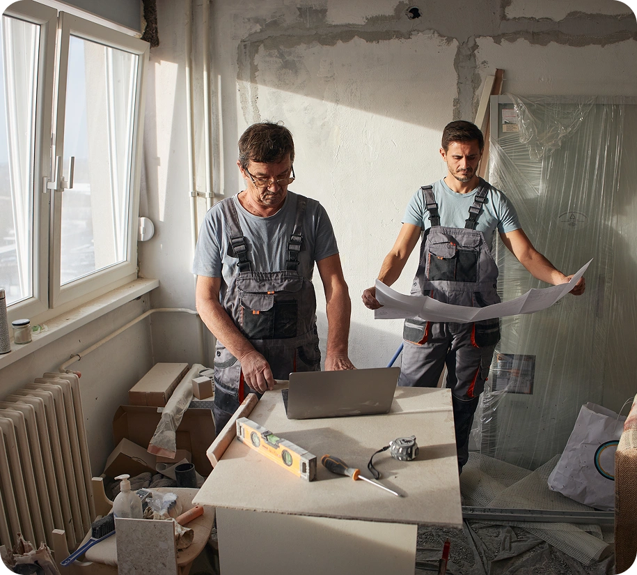 Two builders planning in a renovation site
