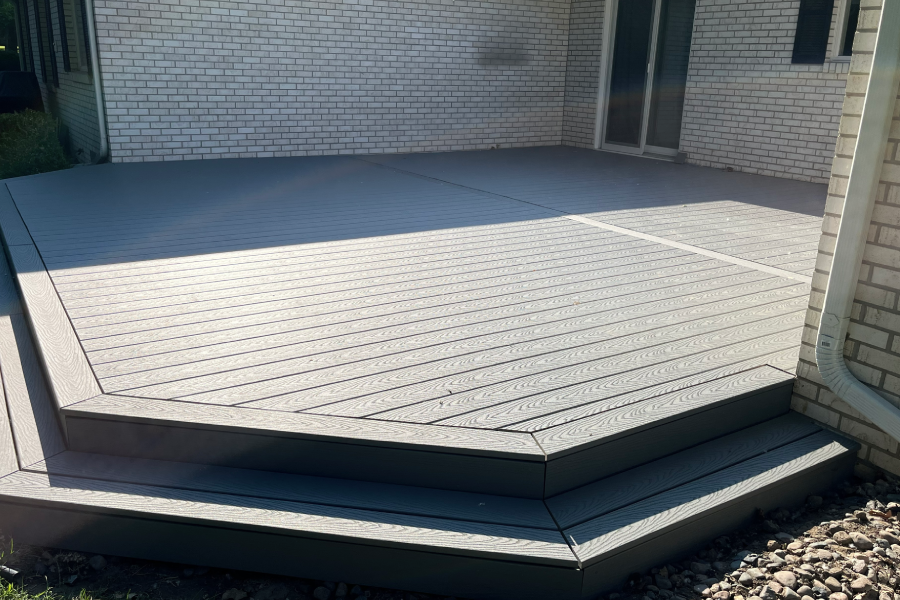 A modern concrete patio with clean lines and a subtle herringbone pattern.
