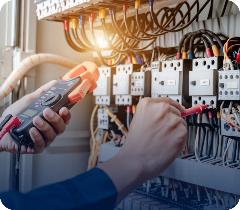 Technician testing electrical equipment