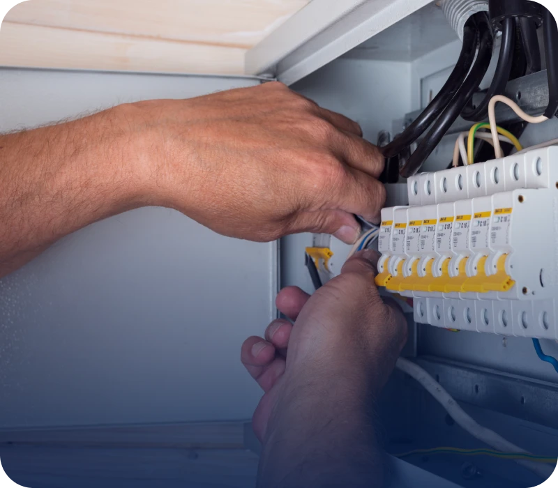 Electrician working on a circuit breaker panel