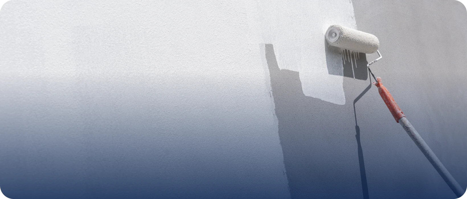 Roller applying white paint on wall